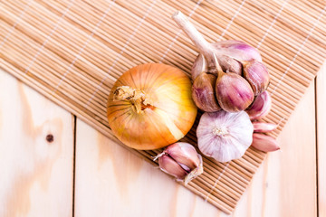 set of onion and garlic on wooden background