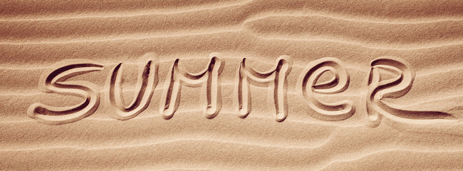 Summer - handwriting on the sea-sand with a wavy pattern