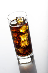 Cola glass with ice cubes over white