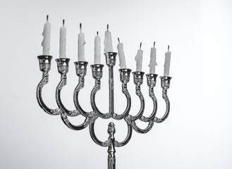 Fototapeta na wymiar Extinct candles on the menorah. End of holiday Hanukkah