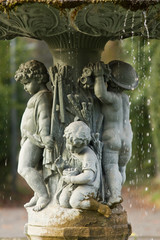 Ornamental fountain with figures of children in the garden
