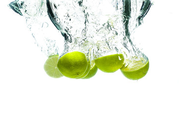 Lime fruits fall deeply under water