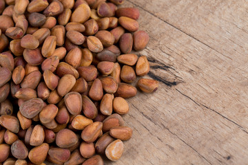 pine nuts on wooden surface