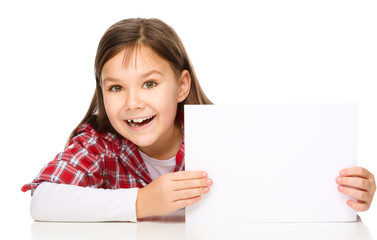 Fototapeta premium Little girl is looking from out blank board
