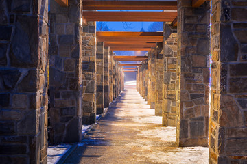 Fototapeta premium Pedestrian path with stone wall perspective