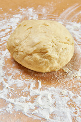 Knead dough on wooden table