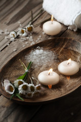 Obraz na płótnie Canvas Spa concept with daisy, white salt and candles