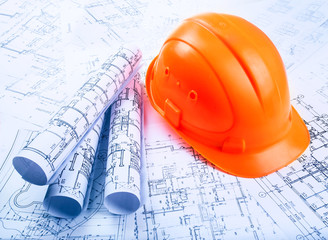 Architectural blueprint rols and helmet