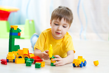 child boy playing with block toys at home