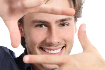 Man with perfect white smile framing face with hands