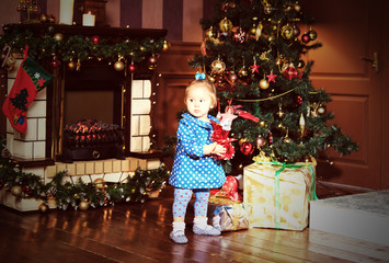 little girl with presents at christmas