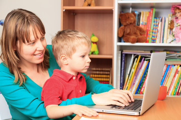 mother working from home with little son