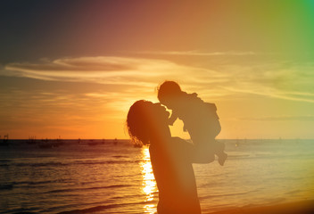 Father and little daughter silhouettes at sunset