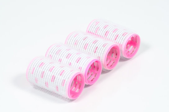 Pink hair curlers with hairpin isolated on white background