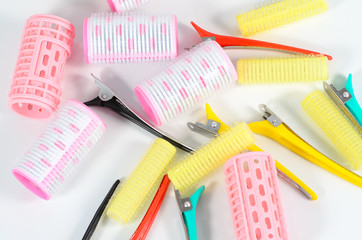 Pink hair curlers with hairpin isolated on white background