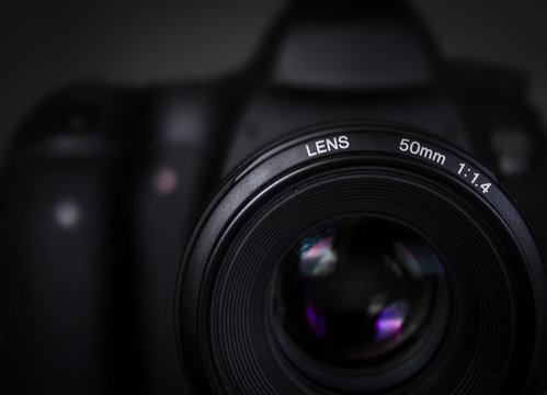 Close-up of DSLR camera with 50mm lens in studio lighting