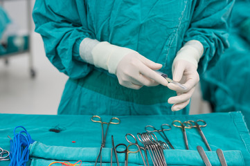 scrub nurse prepare medical instruments for surgery