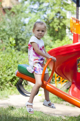 Adorable little girl having fun on a swing outdoor