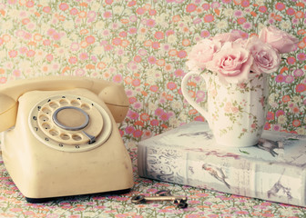 Bouquet of roses in a coffee cup and vintage telephone - 74850747