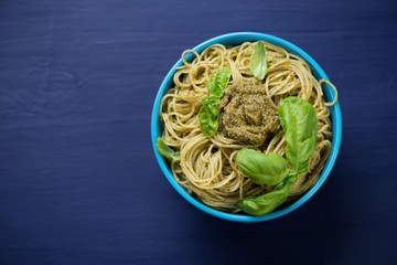 Above view of spaghetti with basil pesto, studio shot