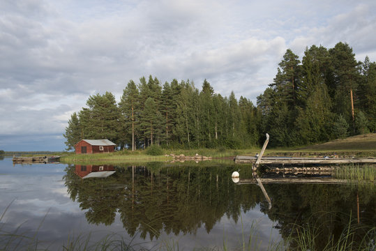 Summer in Sweden - traditional red Cottage at a lake 