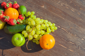 Colorful fruits on brown wood in natural light