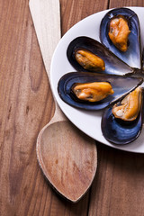 prepared mussels on wooden background