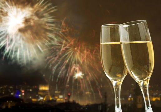 Champagne against fireworks and holiday lights