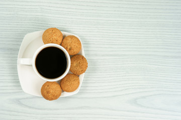 Coffee cup with homemade oatmeal cookies