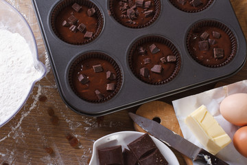 preparation of chocolate muffins closeup top view horizontal