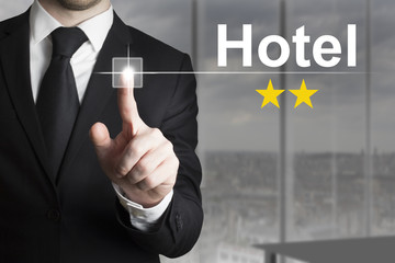 businessman pushing button hotel two stars