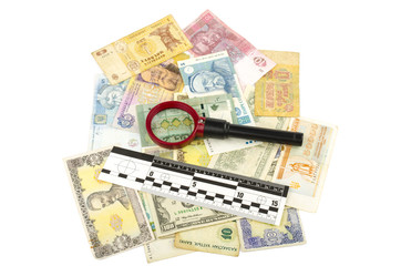 bills and magnifier with ruler of forensic