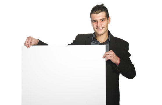 Happy smiling young business man showing blank signboard