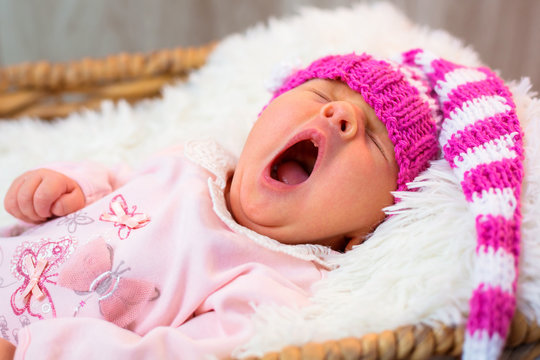 Newborn Baby Girl In Pink Knitted Hat