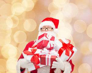 man in costume of santa claus with gift boxes