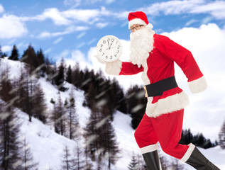 man in costume of santa claus with clock