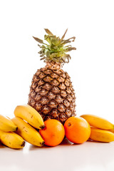 fruit , oranges, bananas , pineapple on white background