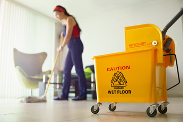Woman Doing Chores Cleaning Floor At Home Focus on Bucket