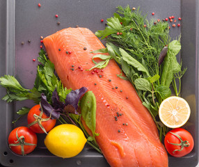Salmon with seasoning on a pan