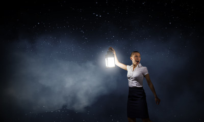 Obraz na płótnie Canvas Businesswoman with lantern