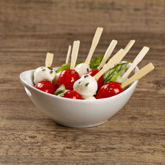 Caprese salad on a sticks with mozzarella, tomatoes and basil