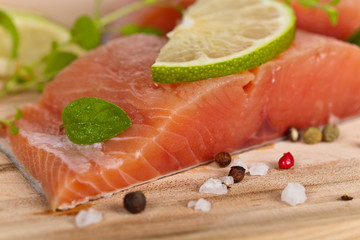 Fresh salmon fillet with oregano and lime slices