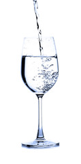 pouring water on a glass on white background