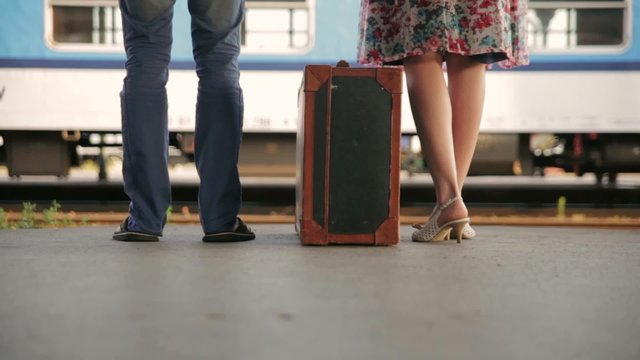 Pair at the station with a suitcase