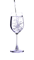 pouring water on a glass on white background