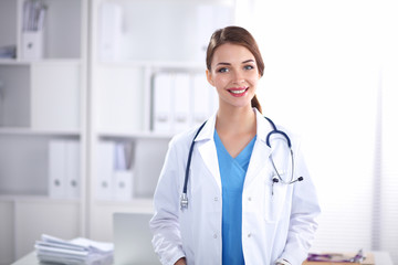 Portrait of happy successful young female doctor holding a