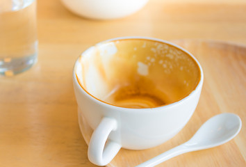 Empty white cup of hot coffee latte on wooden table