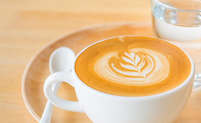 A Latte Coffee art on the wooden desk.