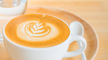 A Latte Coffee art on the wooden desk.