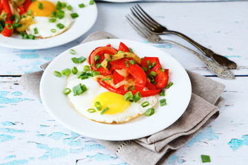 Fried omelet with peppers and onions in a bowl